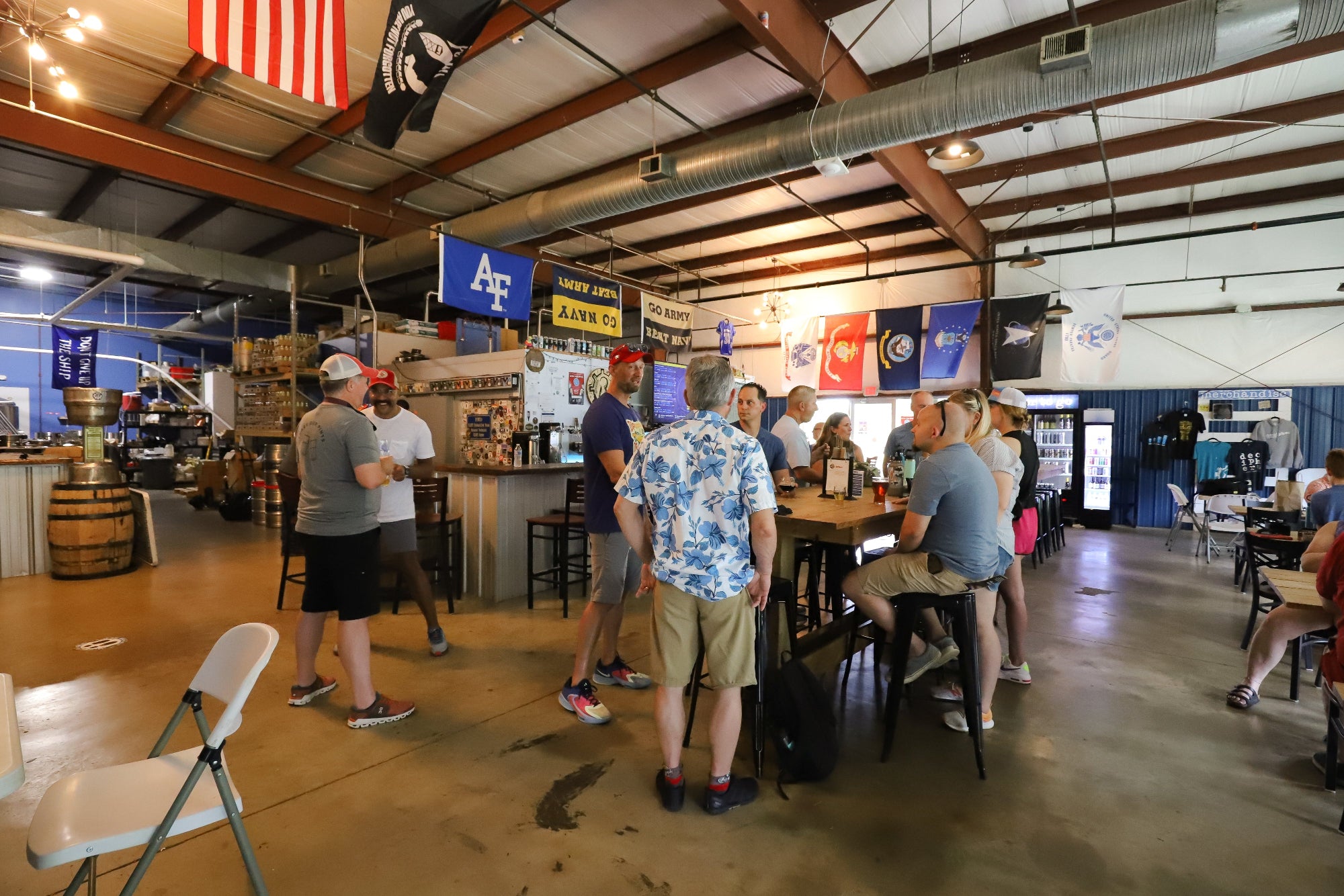 People socializing in a large indoor space with American flags and various decor.