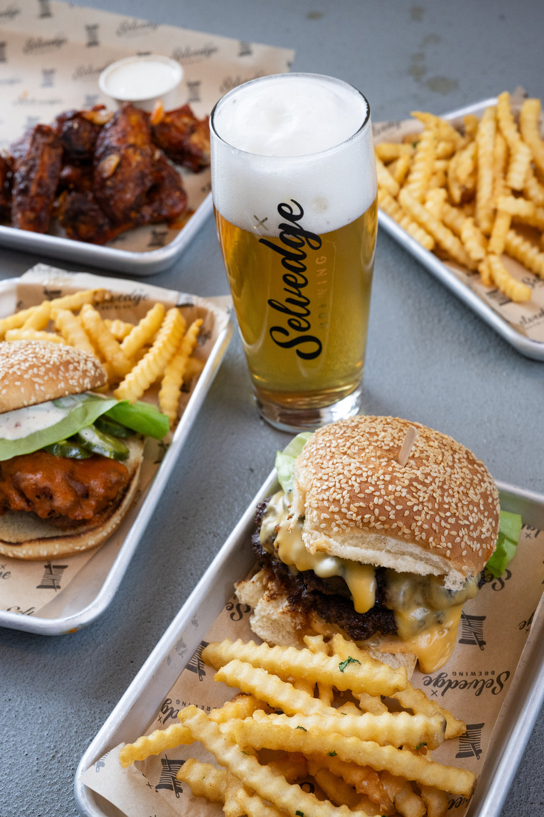 Burgers, chicken, and fries with a beer at Selvedge